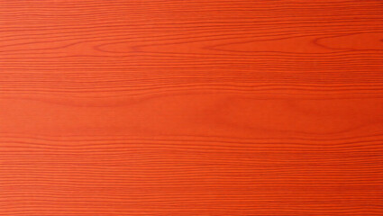 A close up view of an orange wood grain texture with horizontal lines and subtle color variation