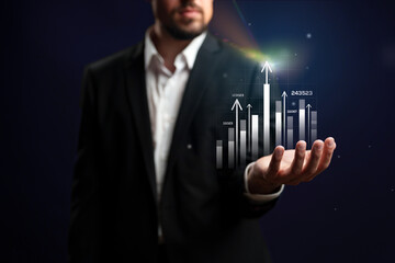 Business professional presenting digital growth graph with upward trends in a modern office setting