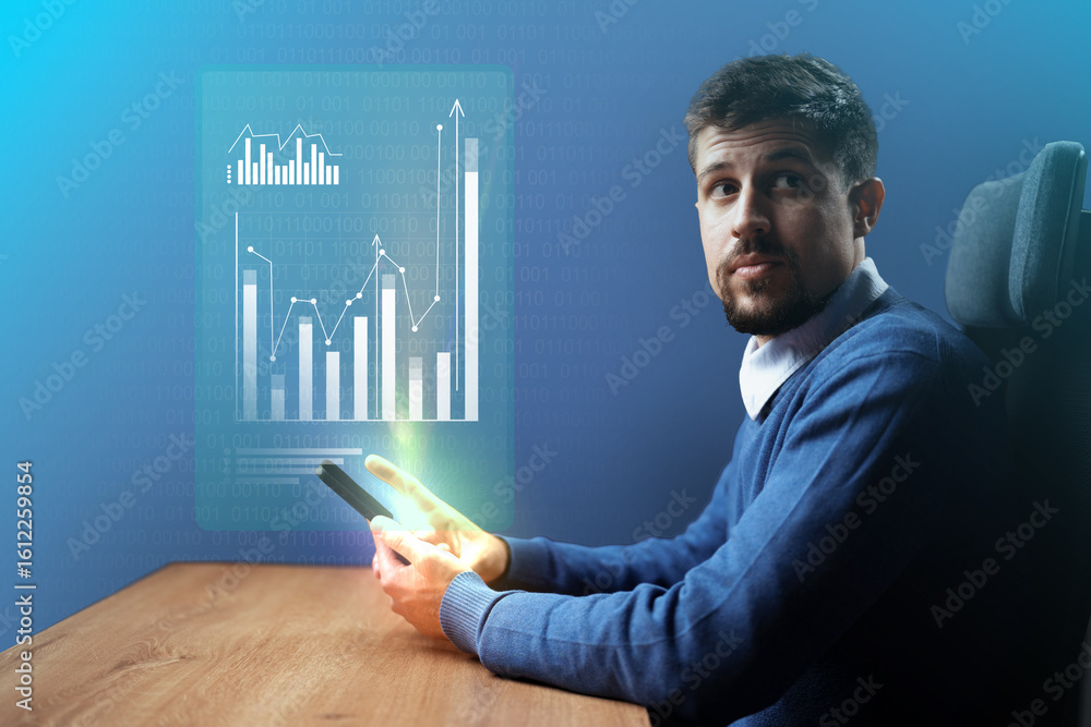 Poster professional man analyzing business data on a mobile device while seated at a modern desk in a well-