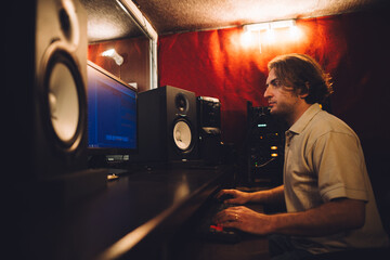 Sound engineer working in recording studio mixing music