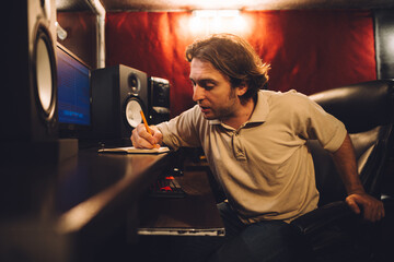 Sound engineer taking notes in a recording studio