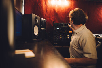 Sound engineer working in recording studio using a mixing console
