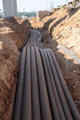 Digital telecommunication network pipes hold cables buried underground. Many electric and high-speed network lines are placed on a construction site in israel