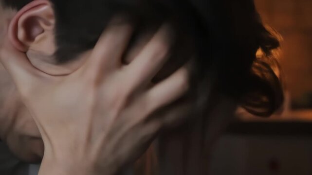 Young man expressing frustration while holding his head indoors  