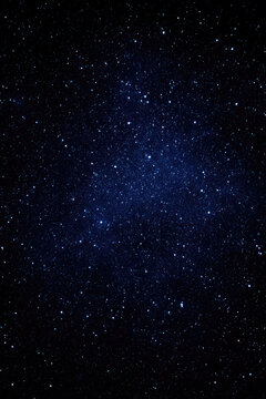 A vast field of stars twinkles in the dark night sky, creating a mesmerizing view of outer space. Cosmic wonder and serenity