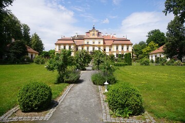 Obraz premium Historic European Mansion with Lush Gardens