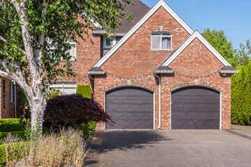 Garage door in luxury house with trees and nice landscape in Summer in Vancouver, Canada, North...