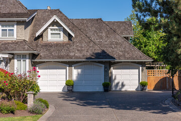 Garage door in luxury house with trees and nice landscape in Summer in Vancouver, Canada, North...