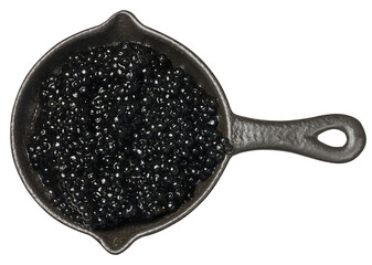 Round black cast-iron pan entirely filled with glistening black caviar. Isolated background