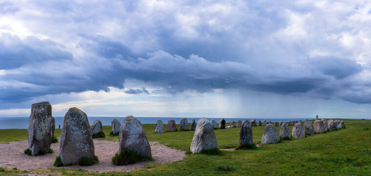 Ale's Stones, in Swedish Ales stenar, a megalithic monument in Scania in southern Sweden. It is a stone ship, Viking burial site. A storm is approaching in the background.