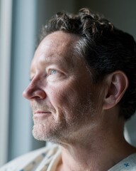 Obraz premium Contemplative caucasian mature male looking out a window