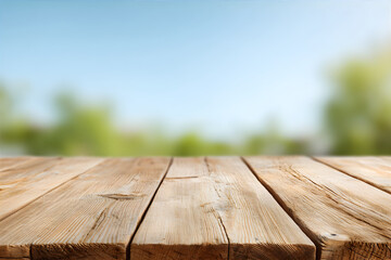 Perspective view of empty wooden table with blurry green leaves and blue sky background. Concept...