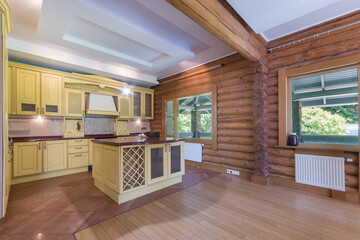 Elegant kitchen in a log cabin with modern design. Large windows provide natural light and a view...