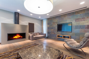 A spacious living room decorated in a modern style with elegant design elements and stylish...