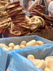 Fresh buns and traditional pretzels are displayed outdoors 
