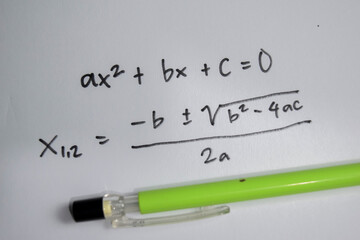 Concept of general quadratic equation write on book isolated on Wooden Table.