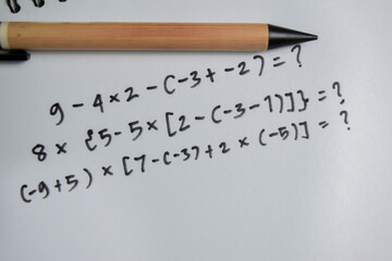 Concept of basic math operation write on book isolated on Wooden Table.