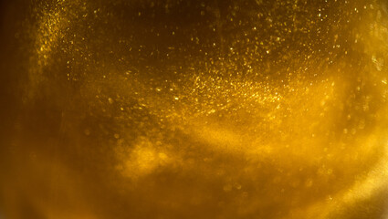 Gold particles floating background, Liquid gold, golden abstract backdrop. Beautiful metallic yellow texture, swirls. Golden dust, Metallic paint close-up. Art Wallpaper waves