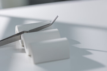 Minimalist manicure tools on light surface, clean elegant beauty salon close-up