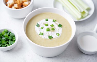 Celery cream soup in a white bowl