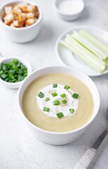 Celery cream soup in a white bowl