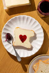 delicious toast with butter and jam heart shaped on pretty cute plate top view. trendy simple breakfast  
