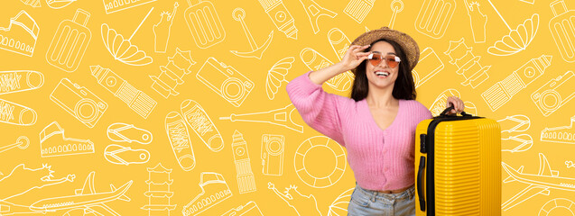 A young woman poses with a vibrant yellow suitcase, wearing stylish sunglasses and a hat. She...