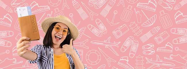 A traveler, wearing sunglasses and a straw hat, joyfully holds her passport and tickets while...