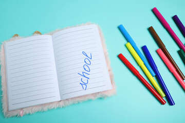 School preparation, pink notebook and colorful markers
