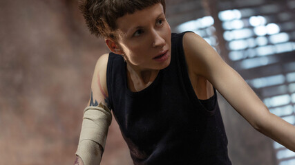 A woman in a boxing gym, portrait by the ropes, close-up. cinematic style, Respite before training, motivation