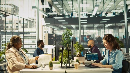 Happy employee starting first day at new job, unpacking belongings, meeting coworkers. Cheerful worker arriving in office, starting work on new company position, being welcomed by team, camera B