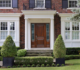 Portico entrance of house with elegant wood grain front door