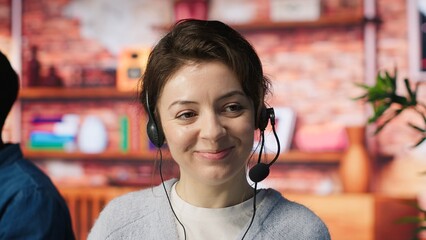 Happy call center employee working on PC, doing account management in office. Cheerful customer...