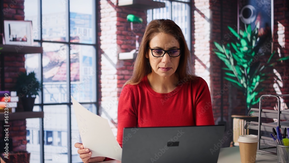 Poster freelancer does her research by reading articles and data driven papers at home, collecting informat
