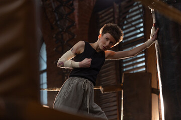 Motivational boxing training scene, woman fighter punching bag in cinematic gym lights