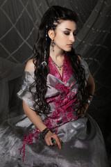 Beautiful woman in Arabic fairytale costume with oriental motifs, dressed for festive costume party