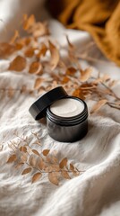 Luxury Skincare Cream Jar with Autumn Leaves on Beige Fabric