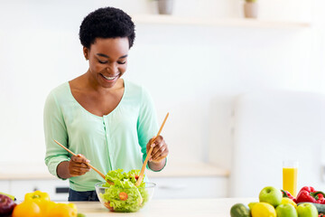 Cooking Leisure. African Woman Making Vegetable Salad Preparing Healthy Dinner Standing In Modern Kitchen At Home. Healthy Eating And Nutrition For Weight Loss Concept.