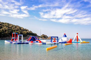 A water inflatable attraction on the seaside. Inflatable trampolines on an early summer morning, a...