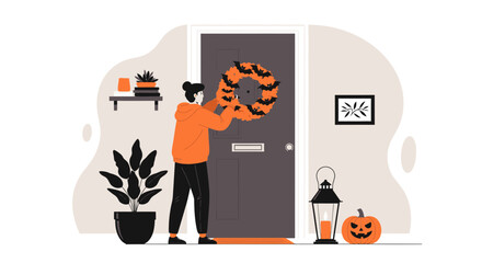 Woman Hangs Halloween Wreath On Front Door For Holiday Decoration