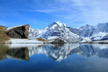 The Jungfrau mountain reflecting in the Grauseewli lake in the fall, Berner Oberland, Schwitzerland