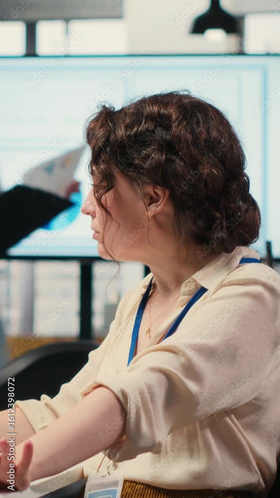 Poster vertical video office administrator checking monthly reports with ai analytics platform, employing n