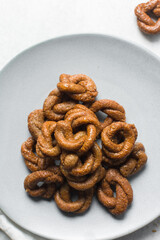 Overhead view of alkaki northern nigerian snack, top view of alkaki snack on a grey plate, Hausa doughnut made with wheat and sugar paste or honey