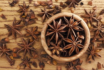 Badian or star anise on wooden background, spices for cooking