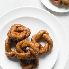 Overhead view of alkaki northern nigerian snack, top view of alkaki snack on a white plate, Hausa doughnut made with wheat and sugar paste or honey
