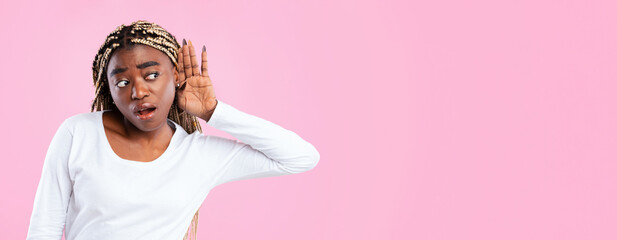 I Can't Hear You. Portrait of curious black woman holding palm of hand near her ear and listening...