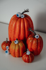 spooky, funny and moody vertical halloween banner with pumpkins, eye candies and bats in the background 