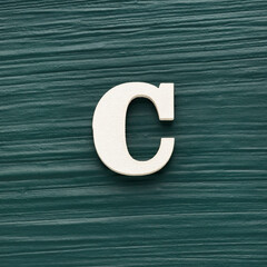 Alphabet letter C, white piece on a dark green rustic background