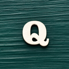 Capital letter Q, White letter on a rustic dark green background