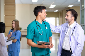Senior doctor is discussing and brainstorming with young nurse on patient medical record after diagnosis for precise care plan with experienced physician specialist